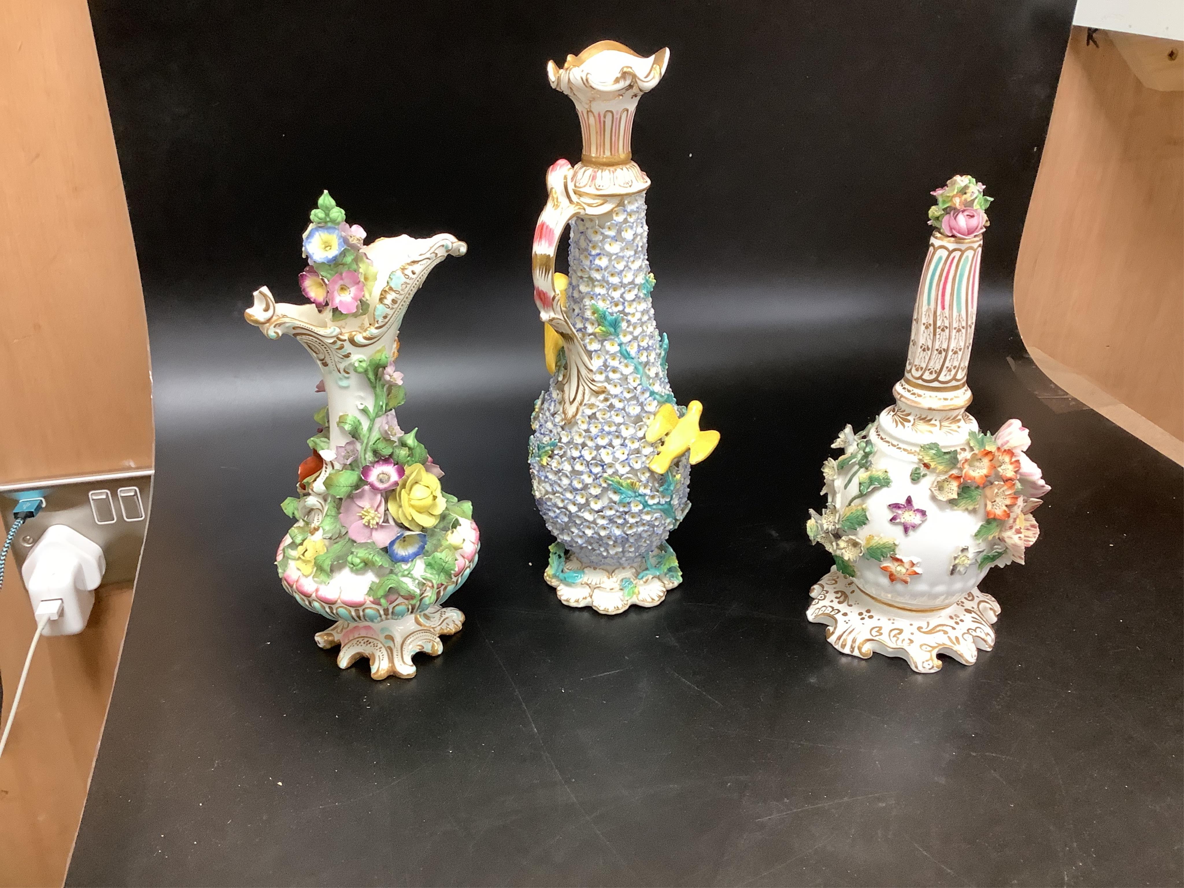 A group of English porcelain flower encrusted scent bottles and yours, Coalport, Minton etc., c.1830-50 together with Continental porcelain figures a wall pocket etc, largest 26cm high